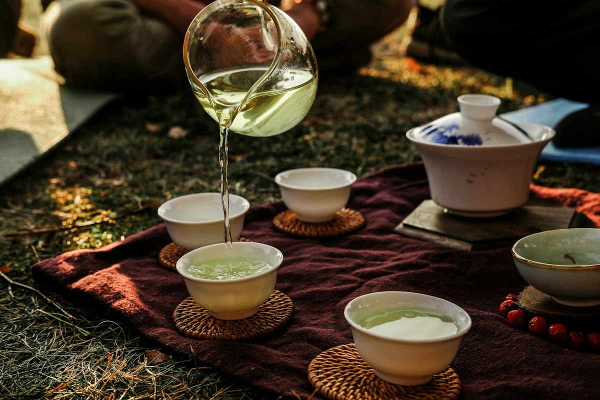 Premium green tea leaves and brewed cup